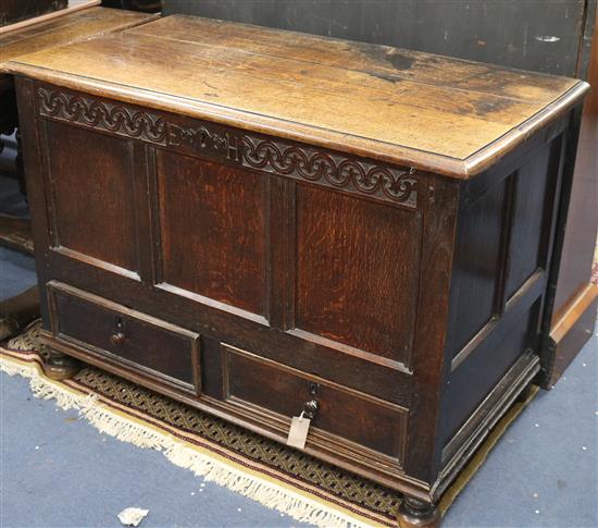 A mid 18th century panelled oak mule chest, monogrammed E.H. W.109cm